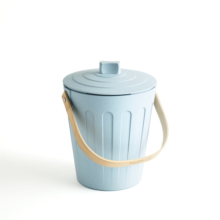 Light blue compost bin with a beige handle on a white background
